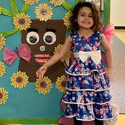 You child showing off a door decorated with flowers at our State Street location.