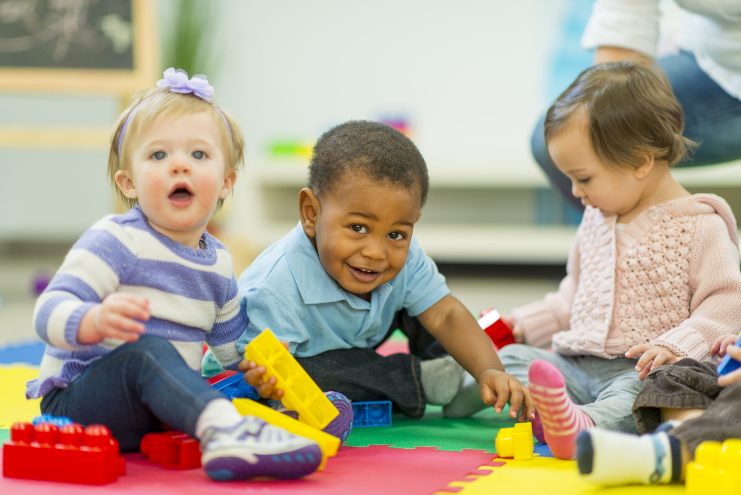 Diverse group of babies playing.