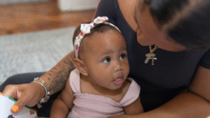 Mother reading to a baby who is looking up at her