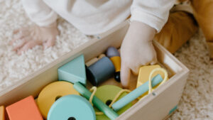 child putting toys away