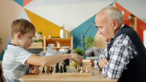 child and grandparent playing a game