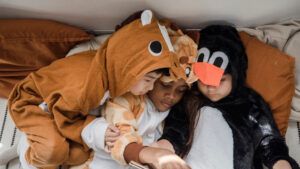 Kids in costume reading a book