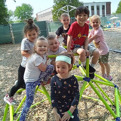 Kids posing on fun climbing equipment at our Enfield, CT learning center.