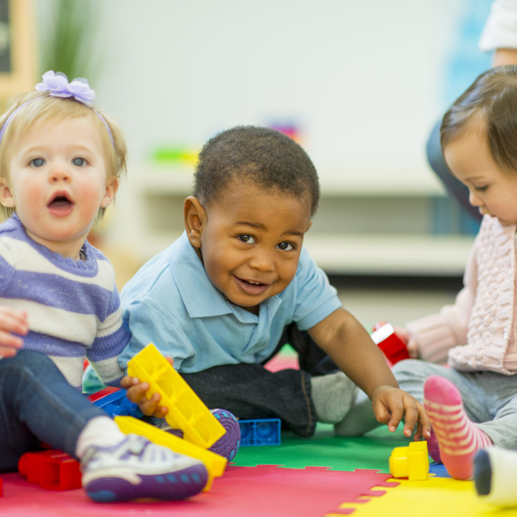 Diverse group of babies playing.